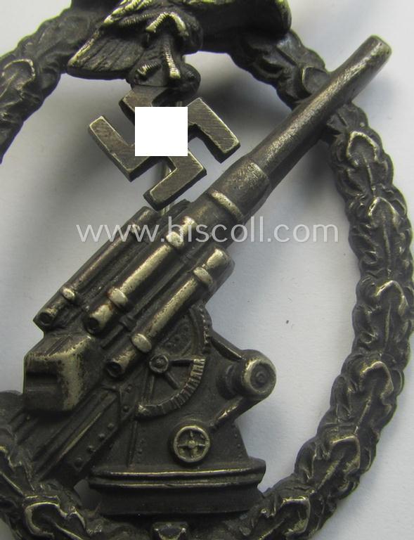 WH (Luftwaffe) 'Flakkampfabzeichen' being a detailed 'Buntmetall'-based and clearly maker-marked example as was produced by the: 'C.E. Juncker'-company and that comes as moderately worn