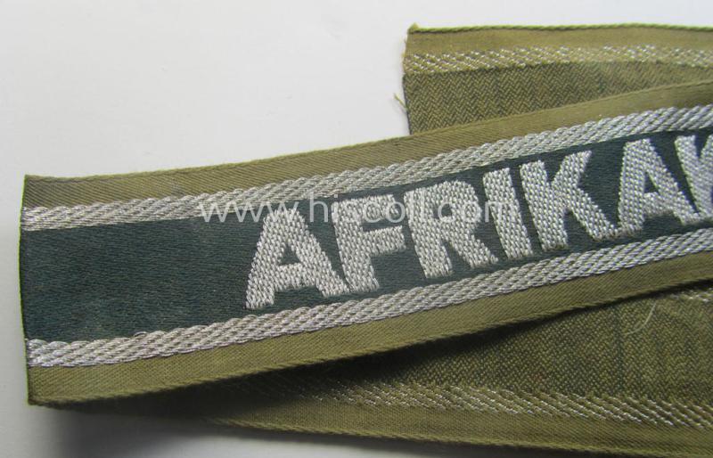 'BeVo'-like cuff-title (ie. 'Ärmelstreifen') entitled: 'Afrikakorps' being a presumably issued but simply never worn example that comes in an overall very nice- (ie. non-shortened- and never tunic-attached-), condition
