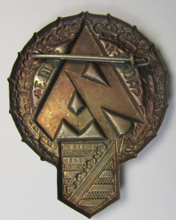 Commemorative, hollow-back- and/or silvered tin-based so-called: SA- (ie. 'Sturmabteilungen'-) related 'tinnie' being a non-maker-marked example showing a larger-sized SA-logo, provincial-shield and text: 'Sachsen - 25.III.34'