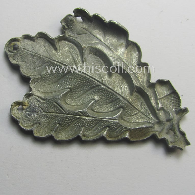 Truly used- and/or worn, WH (Heeres) greyish-silver-coloured so-called: 'M43'-pattern cap-badge (ie. 'Mützenabzeichen') depicting three: 'Eichenlaub'-branches as was used by the various 'Jäger'-related, divisional staff-members