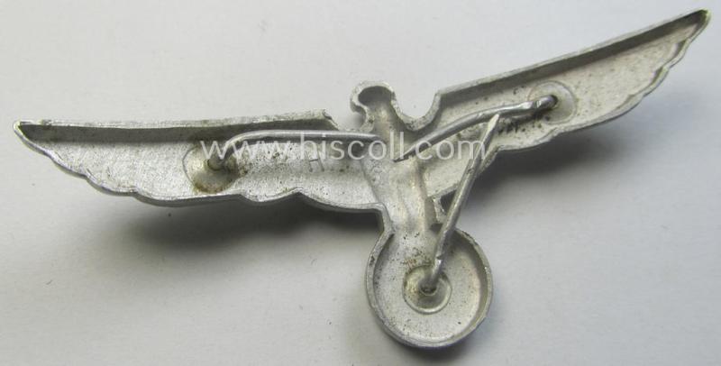 WH (Heeres) bright-silver-toned (ie. typical aluminium-based), EM- (ie. NCO- or officers') type visor-cap-eagle being a maker- (ie. 'R.H.'-) marked and/or: '1938'-dated example that comes in a moderately used- ie. once cap-attached-, condition