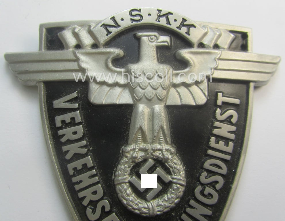 Superb - quite rarely seen and very detailed! - aluminium-based, N.S.K.K.-related armshield (ie. 'Ärmelshield') depicting the typical N.S.K.K.-eagle-device and text that reads: 'Verkehrserziehungsdienst'
