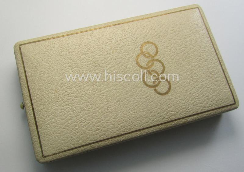 'Deutsche Olympia-Erinnerungsmedaille 1936' being a non-maker-marked example that comes mounted onto its original ribbon (ie. 'Bandabschnitt') and that comes stored in its typical, beige-white-coloured etui