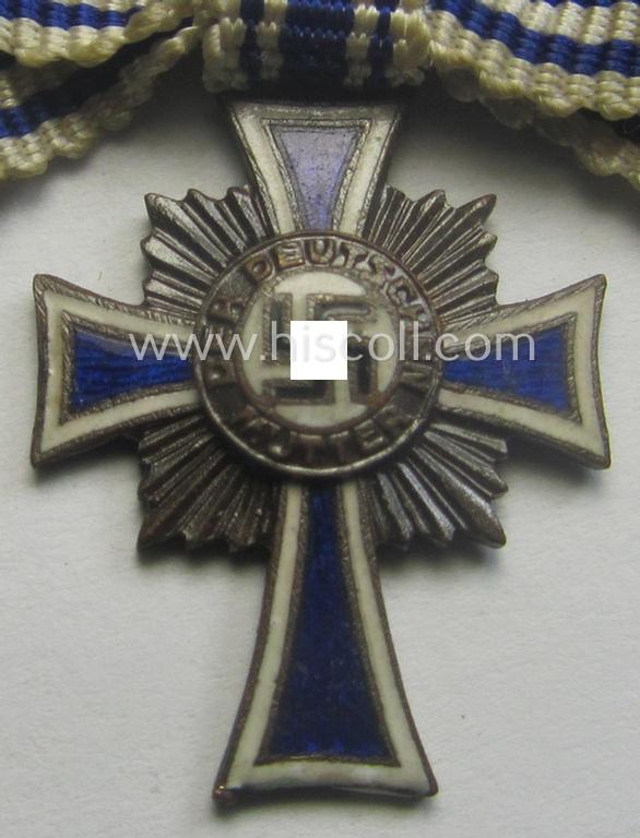 Miniature of an: 'Ehrenkreuz der deutschen Mutter - dritte Stufe' (or: bronze-class mothers'-cross) being a non-maker-marked example that comes in an overall nice- (albeit moderately worn- ie. used-), condition
