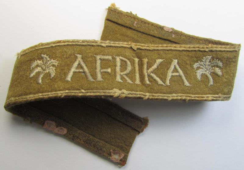 Attractive, WH (LW o. Heeres) cuff-title (ie. 'Ärmelstreifen') entitled: 'Afrika' (being a period-shortened- and woolen-based example that comes in a clearly issued- and/or worn condition)