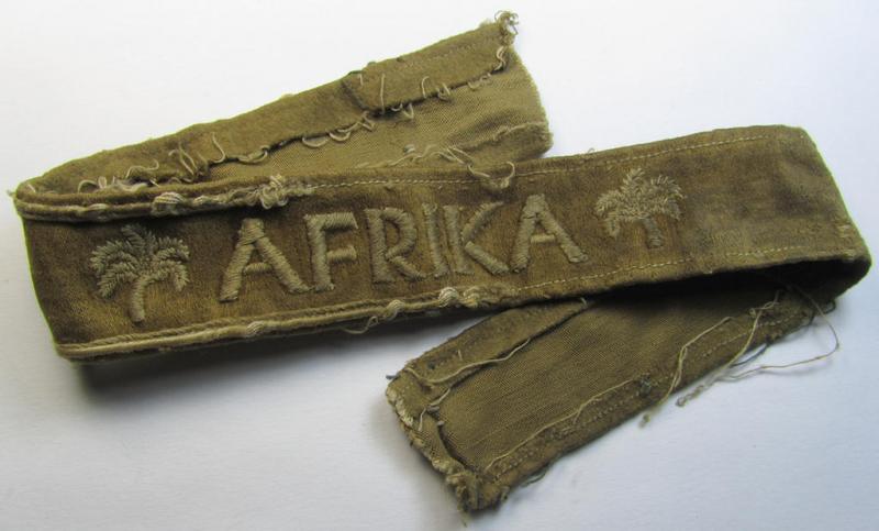 Attractive - and clearly worn! - WH cuff-title (ie. 'Ärmelstreifen') entitled: 'Afrika' (being a period-shortened example that comes in an overall nice- ie. issued and clearly worn ie. once tunic-attached, condition)