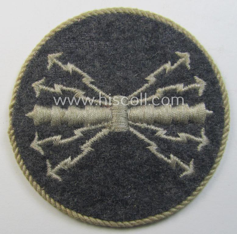 Attractive - and hardly used! - example of a WH (Luftwaffe) machine-embroidered, trade- ie. special-career-patch (ie. 'Tätigkeitsabzeichen') having a silverish-grey-toned 'Kordel' attached as was intended for: 'LW-Funk-Unteroffiziere'