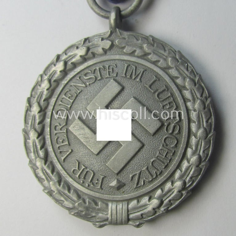 'Luftschutz-Ehrenzeichen 2. Stufe' being a non-maker-marked example as executed in (light-weight) aluminium-based metal and that comes mounted onto its period (confectioned) ribbon ie. 'Bandabschnitt'