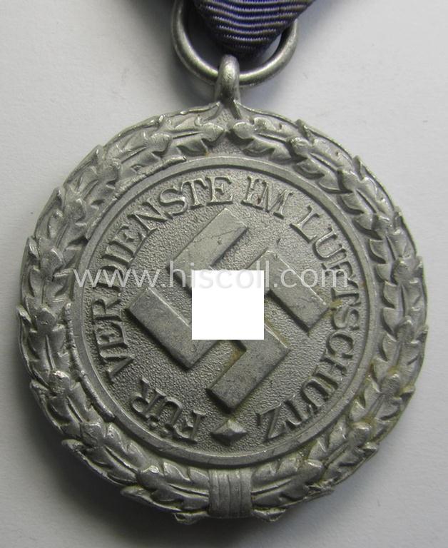 Light-weight (ie. typical aluminium-based) medal as was intended for air-raid wardens 2nd. class (or: 'Luftschutz-Ehrenzeichen 2. Stufe') that comes stored in its period, dove-grey-coloured etui