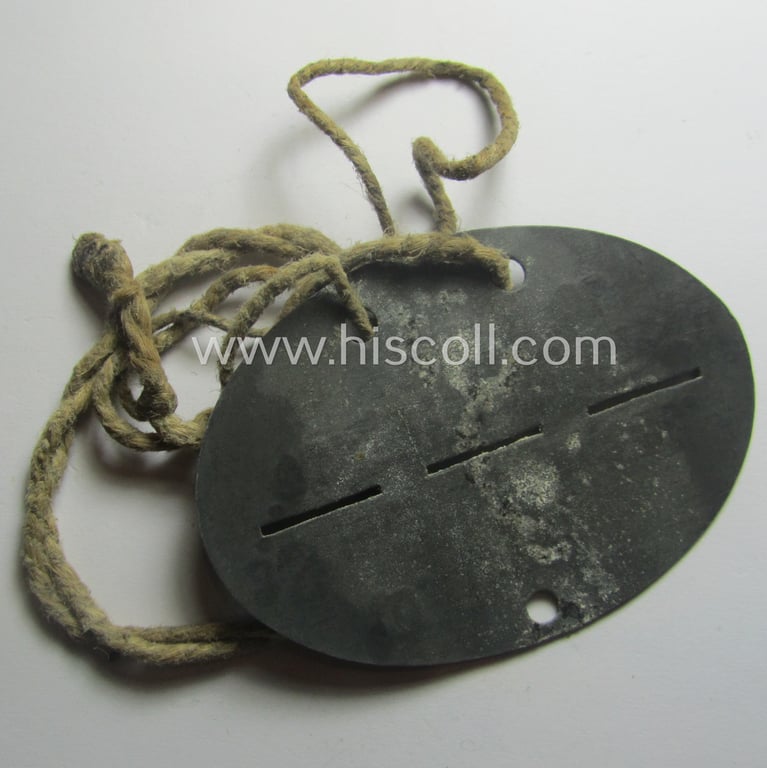 Zinc-based, WH (Luftwaffe) ie. 'LW-Flak-Helfer'-related ID-disc (ie. 'Erkennungsmarke') bearing the stamped unit-designation: '10. LW.H. / 3. Schw. Flak Abt. 514' and that comes mounted onto its cord as issued- and/or worn