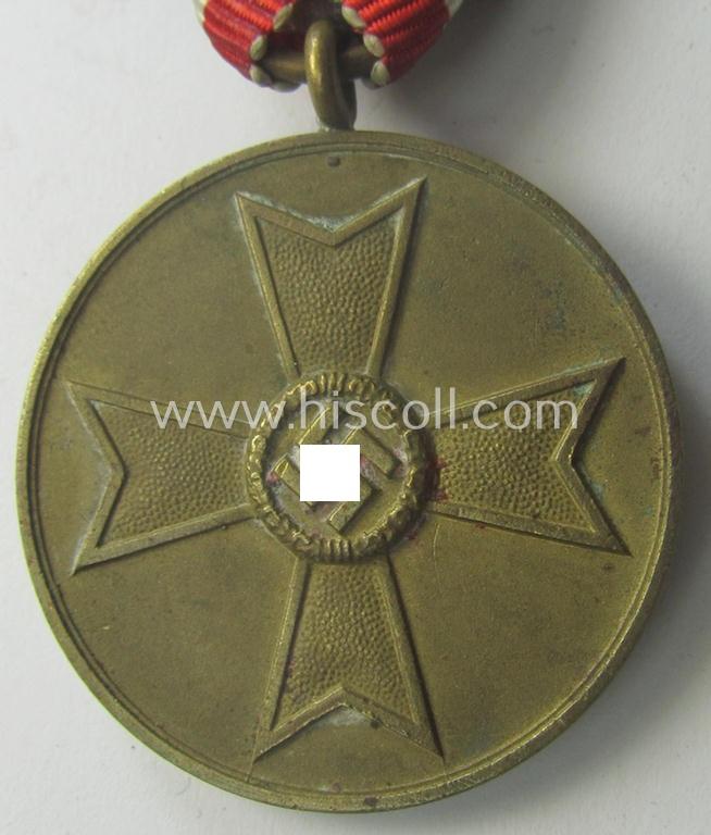 Medal-set: 'Kriegsverdienstmedaille 1939' being a (typical) non-maker-marked- (and 'Buntmetall'-based) specimen that came mounted onto its (scarcely seen!) bright-red-coloured- and/or Austrian-styled ribbon (ie. 'Bandabschnitt')