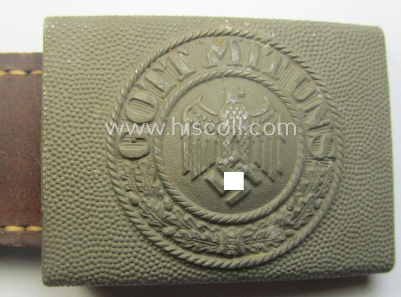 WH (Heeres) 'standard-pattern', field-grey-toned- and aluminium-based belt-buckle being a maker- (ie. 'E. Schneider - Lüdenscheid'-) marked- and/or: '1938'-dated example that comes mounted onto its leather-based tab