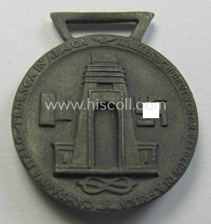 Attractive, bronze-coloured- (and I deem 'Feinzink'-based-) example of a: 'Deutsch-Italienische Feldzugsmedaille' (or: German-Italian campaign medal) that came together with its (regular-sized- and never mounted) piece of original ribbon