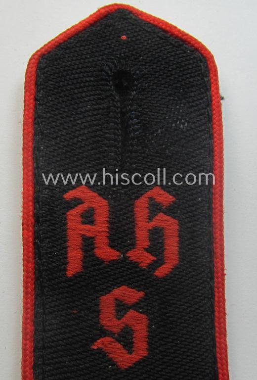 Superb - and rarely encountered! - red-piped, so-called: 'Allgemeine' HJ ('Hitlerjugend') shoulderstrap as was intended for a student who served within one of the: 'Adolf Hitler Schulen' (still having the remains of its 'RzM'-etiket attached)