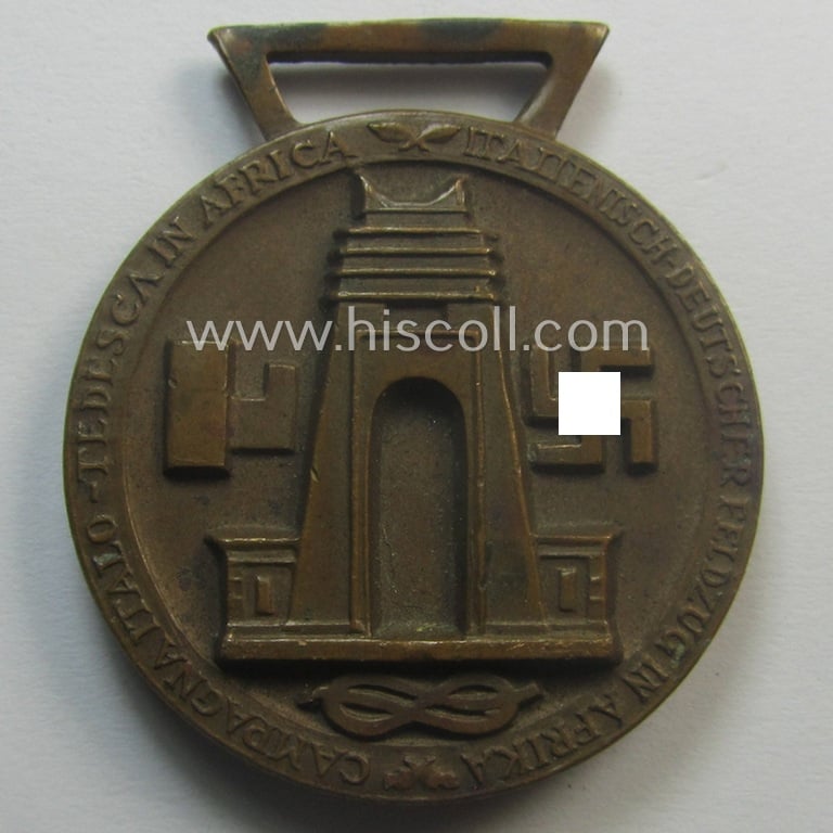 Golden-bronze-coloured (and 'Buntmetall'-based!) example of a: 'Deutsch-Italienische Feldzugsmedaille' (or: German-Italian campaign-medal) that came together with its (full length- and 'virtually mint- ie. unissued') piece of original ribbon