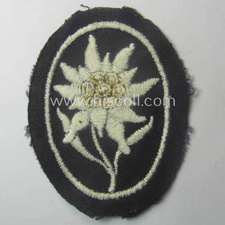 Waffen-SS-pattern, black-coloured sleeve-insignia (ie. 'Ärmelabzeichen') depicting an: 'Edelweiss'-flower as used by the various 'Gebirgsjäger'- (ie. mountain-troops-) related divisional-staff