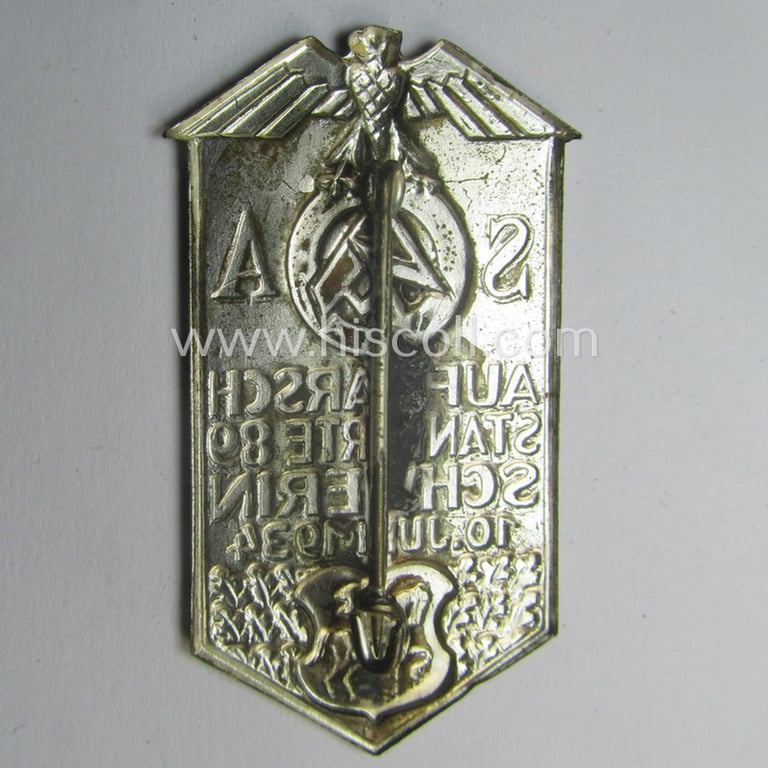 Commemorative, SA- (ie. 'Sturmabteilungen'-) related 'tinnie' depicting an illustration of an 'SA'-logo and typical 'Reichsadler'-device coupled with the text: 'Aufmarsch - Standarte 89 - Schwerin - 10. Juni 1934'
