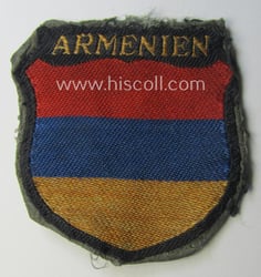 Truly used- and/or worn, multi-coloured- and/or 'BeVo'-woven armshield...