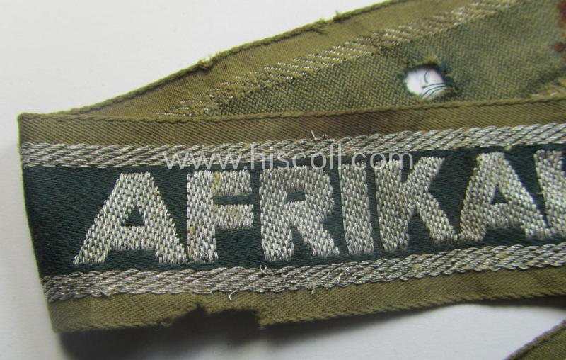 Relic, 'BeVo'-like cuff-title (ie. 'Ärmelstreifen') entitled: 'Afrikakorps' being a clearly issued and/or worn example that comes in an overall nice- (ie. hardly shortened- albeit somewhat damaged-), condition
