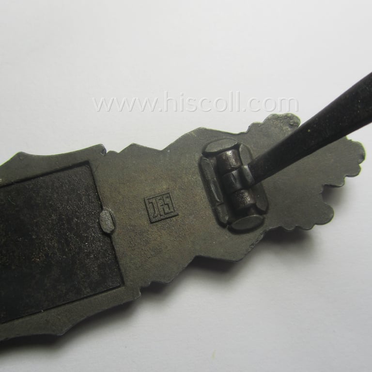'Nahkampfspange in Bronze' (or: bronze-class close-combat clasp ie. CCC) being a neatly maker-marked- and/or minimally converse-shaped specimen as was produced by the: 'JFS'- (ie. 'Joseph Feix u. Söhne'-) company
