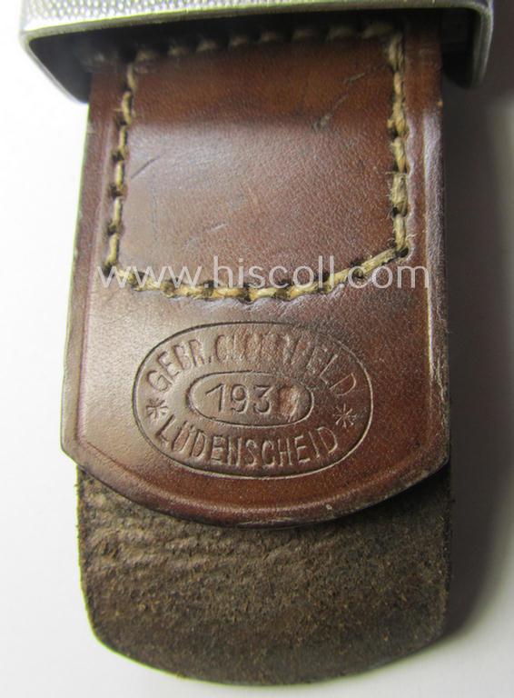 WH (Heeres) 'standard-pattern', field-grey-toned- and aluminium-based belt-buckle being a maker- (ie. 'Gebr. Gloerfeld'-) marked- and/or '1938'-dated example that comes mounted onto its leather-based tab