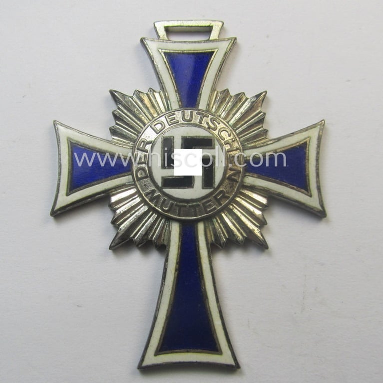 'Ehrenkreuz der deutschen Mutter - zweite Stufe' (or: silver-class mothers'-cross) that came together with its 'rolled-up' ribbon as issued and recently found