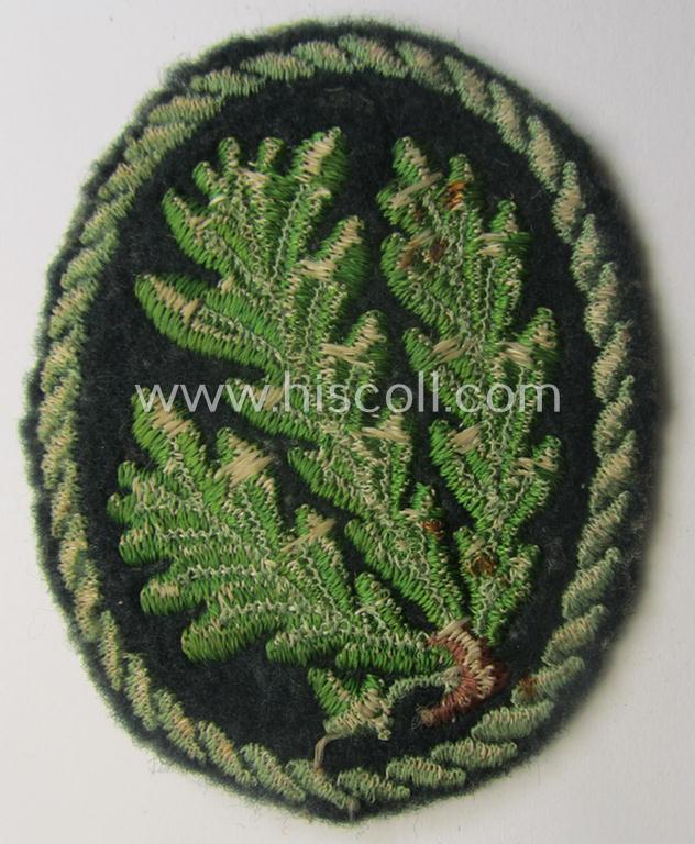 Truly used WH (Heeres) so-called: 'Jäger'-armbadge being a neatly machine-embroidered- and/or multi-coloured version as was executed on darker-green-coloured 'felt-based'-wool