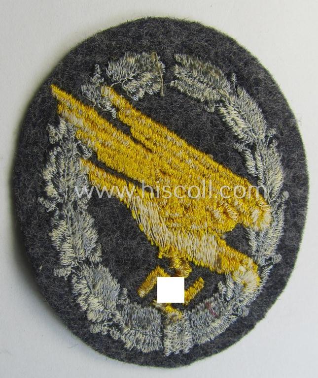 WH (LW) 'Fallschirmschützen-Abzeichen in Stoff' (or: cloth-based paratroopers'-jump-badge) being a nicely machine-embroidered specimen that comes in a probably issued albeit (I deem) never used- ie. 'virtually mint', condition