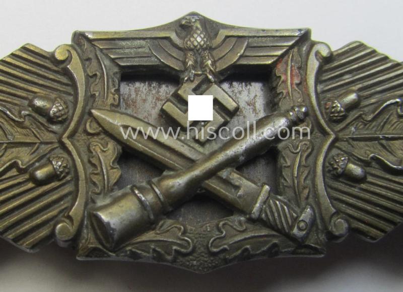 'Nahkampfspange in Bronze' (or: bronze-class close-combat clasp ie. CCC) being a maker- (ie. 'A.G.M.u.K.'-) marked- and/or minimal converse-shaped specimen having its period-attached (steel-based) 'back-plate' in place