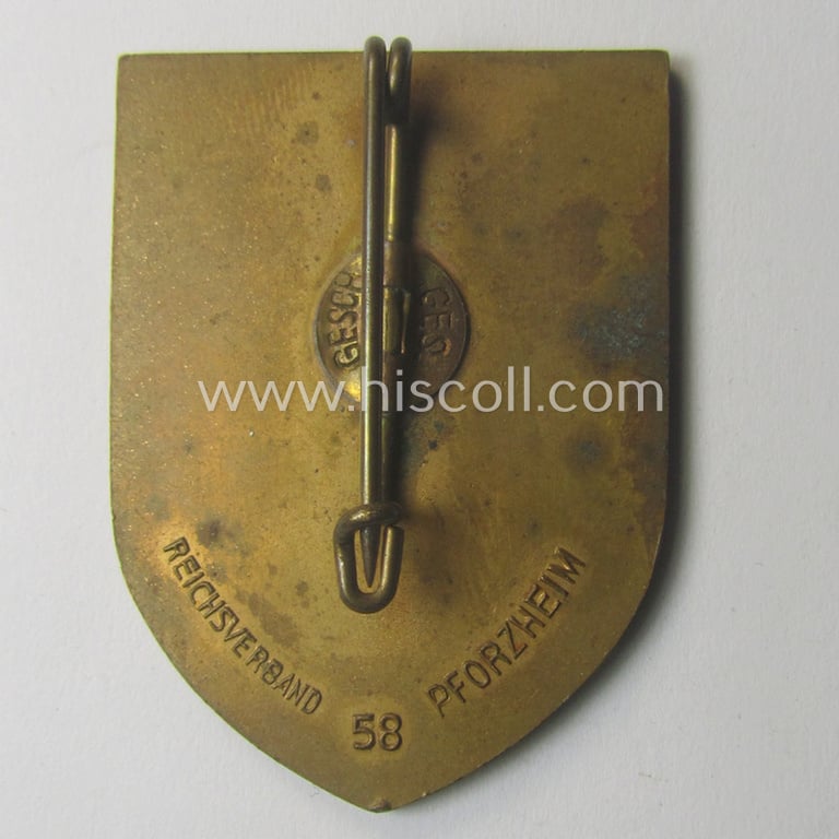 Commemorative, golden-toned, 'DAF'/'HJ'- (ie. 'Deutsches Arbeits Front o. Hitlerjugend'-) related 'tinnie' being a maker- (ie. 'RV 58 Pforzheim'-) marked example depicting the text: 'Reichs-Berufs-Wettkampf der deutschen Jugend 1934'