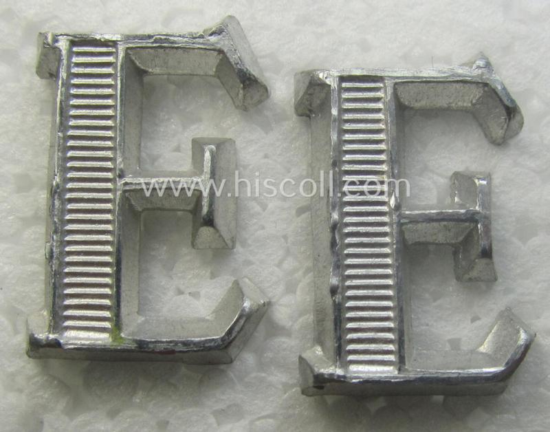 Pair of NCO-type- (thus silver-coloured), Waffen-SS- (ie. SS-VT-) related shoulderstrap-cyphers (ie. 'Schulterstückauflagen o. Ziffern') depicting a capital 'E'-character for usage by an NCO serving within the: 'Ergänzungsstellen der Waffen-SS'