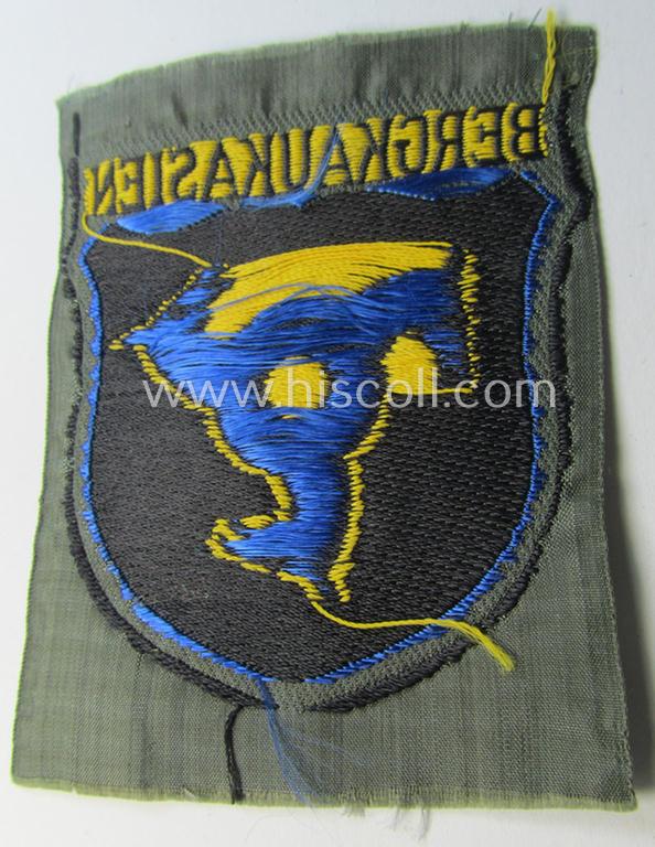 Attractive, 'BeVo'-type armshield (of the second pattern-) entitled: 'Bergkaukasien', being a piece as intended for a volunteer who served within the 'Deutsche Wehrmacht' ie. within the 'Berg- o. Nord-Kaukasisches Legion'