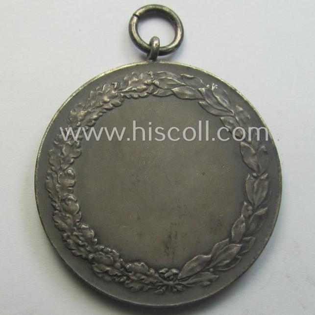 Unusually seen, frosted-silver-toned and TR-period shooting-medal showing on its front a uniformed hunter and that is entitled: 'Schützenkönig 1937/38 - Peter Fücker'