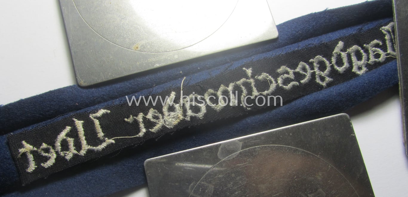 Moderately used, WH (Luftwaffe) cuff-title ie. armband (ie. 'Ärmelstreifen') entitled: 'Jagdgeschwader Udet' that comes in a clearly worn- ie. carefully tunic-removed-, condition