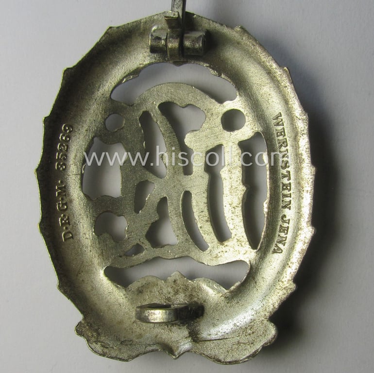 'Reichssportabzeichen DRL in Silber' (or: DRL sports'-badge in silver) being a just moderately worn- ie. used example that is nicely maker- (ie. 'Wernstein - Jena'-) marked on its back