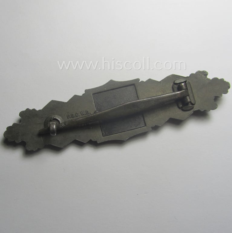 'Nahkampfspange in Bronze' (or: bronze-class close-combat clasp ie. CCC) being a neatly maker-marked- and/or minimally converse-shaped specimen as was produced by the: 'JFS'- (ie. 'Joseph Feix u. Söhne'-) company