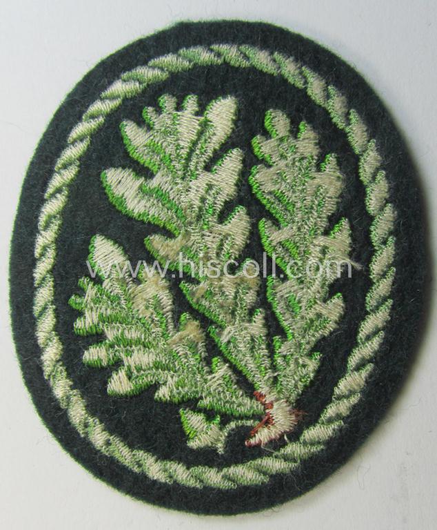 Attractive example of a WH (Heeres) so-called: 'Jäger'-armbadge being a neatly machine-embroidered- and/or multi-coloured version as was executed on darker-green-coloured wool