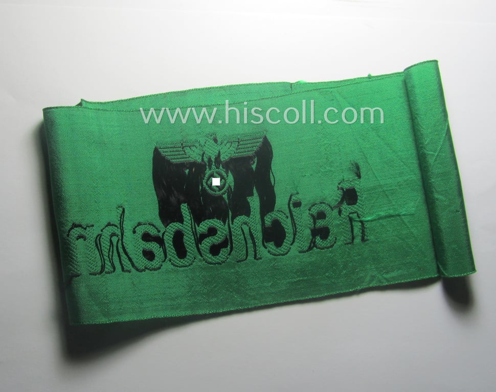 DRB- (ie. 'Deutsche Reichsbahn'-) related armband entitled: 'Reichsbahn' being of the 'entirely-woven'-type onto (typical shiny) 'silk-like' cloth in a technique similar to the 'BeVo'-weave pattern