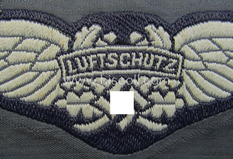 Attractive - and scarcely encountered! - EM- (ie. NCO-) pattern, so-called: 'Luftschutz' (ie. RLB-) cap-badge (ie. 'Mützenabzeichen') as executed in so-called: 'BeVo'-weave-pattern and that comes in a 'virtually mint- ie. unissued' condition