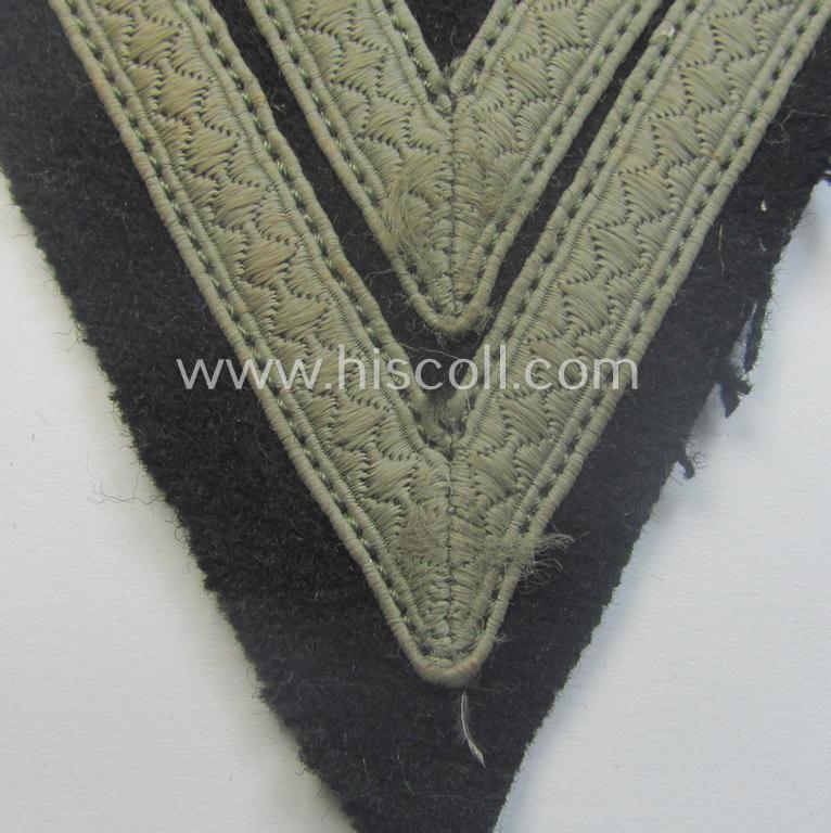 Truly used- and/or tunic-removed, Waffen-SS- (ie. Heeres Panzer-) type 'Armwinkel' (or: rank-chevron) as executed on black-coloured wool as was intended for an: 'SS-Rottenführer' (ie. 'Obergefreiter')
