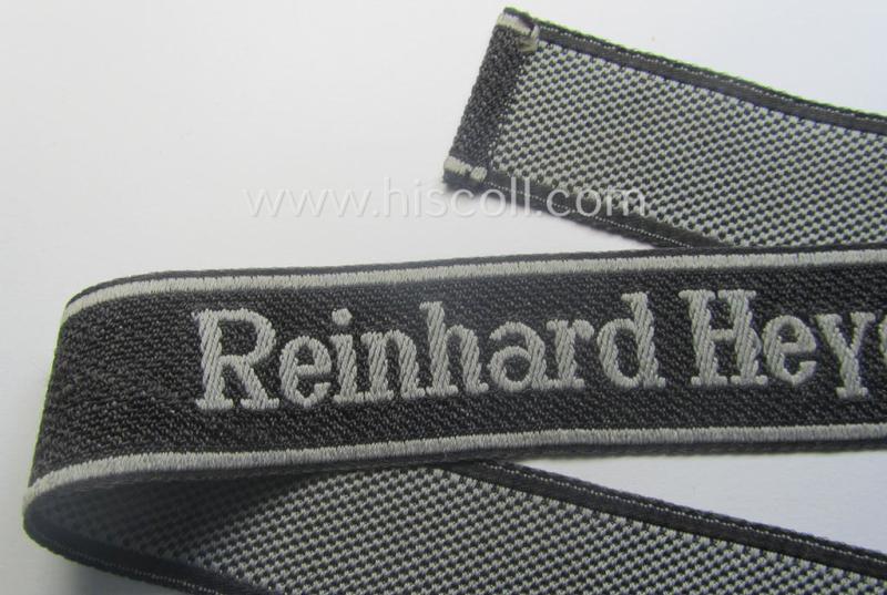 Waffen-SS, 1943-pattern cuff-title (ie. 'Ärmelstreifen') depicting the machine-woven Latin script text in silver-grey linnen as was intended for a member of the: 'SS-Geb.Jäg.-Rgts. 6. (u.11.)': "Reinhard Heydrich"
