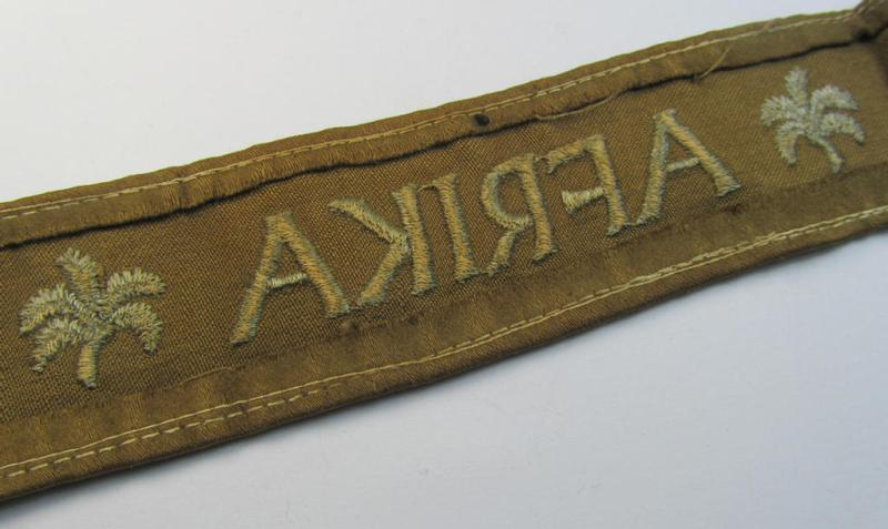 Attractive, WH (LW o. Heeres) cuff-title (ie. 'Ärmelstreifen') entitled: 'Afrika' (being a period-shortened- and woolen-based example that comes in a clearly issued- and/or worn condition)