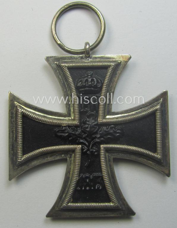 WWI-period: 'Eisernes Kreuz II. Klasse' (or: iron cross second class) being a maker- (ie. 'KO'-) marked example that comes together with its (minimally) confectioned piece of ribbon (ie. 'Bandabschnitt')