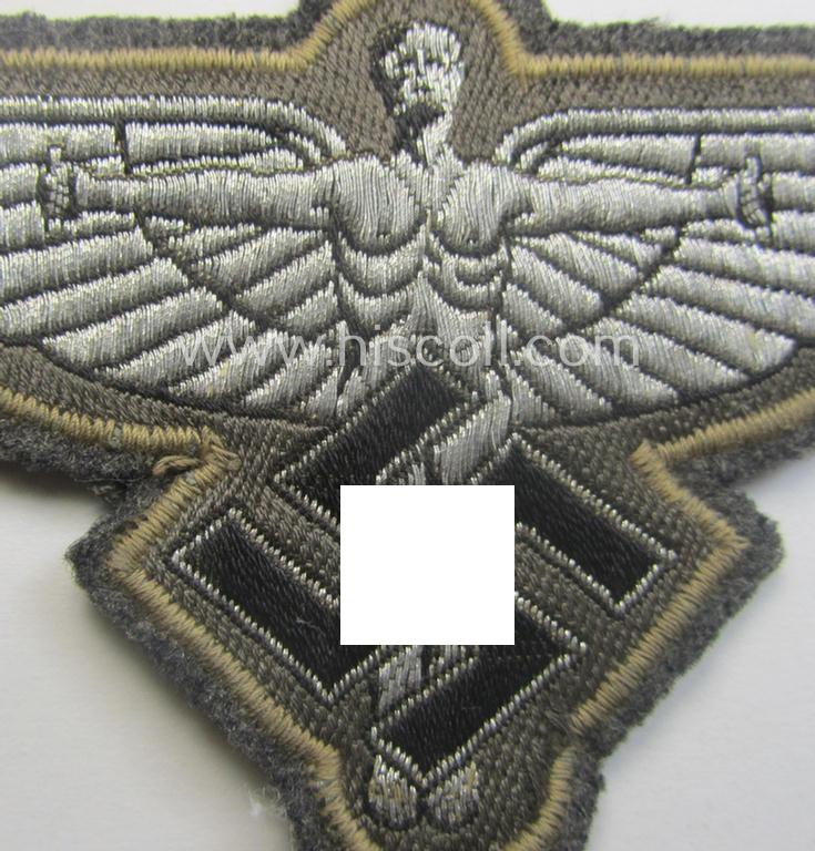 Bluish- (ie. silver-) coloured, so-called: N.S.F.K.- (or: 'National Socialistisches Flieger Korps') breast-eagle being a nicely woven- (and officers'-pattern) example that comes mounted on its piece of bluish-grey-coloured linnen