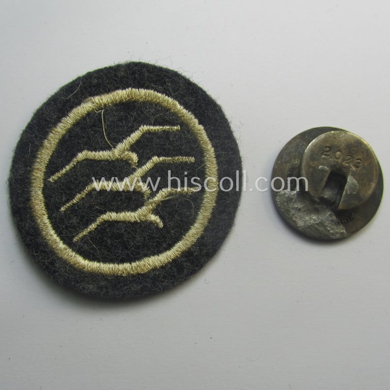 Neat, 2-pieced set comprising of an enamelled (and embroidered!) example of a: DLV (ie. 'Deutscher Luftsportsverband') related so-called: 'Segelflieger-C-Abzeichen' (of which the enamelled example bears the serial-number: '2022')