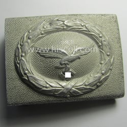 WH (LW) silver-coloured and/or aluminium-based belt-buckle (being of...