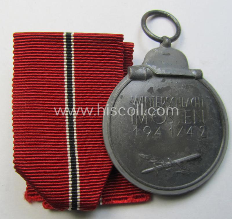 Attractive medal-set: 'Winterschlacht im Osten 1941-42' being a maker- (ie. '60'-) marked- (and/or 'Feinzink'-based) specimen by the maker: 'Katz & Deyhle' and that comes together with its (minimally confectioned) ribbon (ie. 'Bandabschnitt...