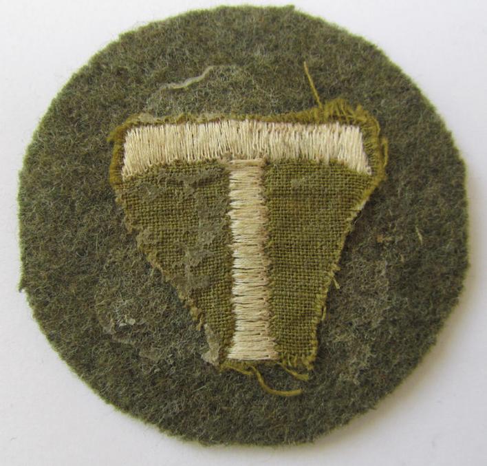 Interesting - and with certainty rarely encountered! - (IMO) OT- (ie. 'Organisation Todt'-) related, machine-embroidered-, trade- ie. special-career-patch as was executed in greenish-brown-coloured wool and depicting a 'T'-character