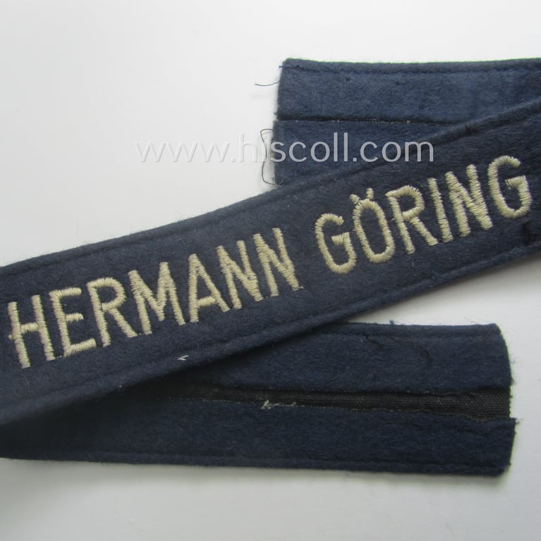 Truly used- and/or tunic-removed, typical 'smooth-woolen'-based, EM- (ie. NCO-) pattern WH (Luftwaffe) cuff-title (ie. 'Ärmelstreifen') entitled: 'Hermann Göring' that comes in that comes in an overall very nice condition