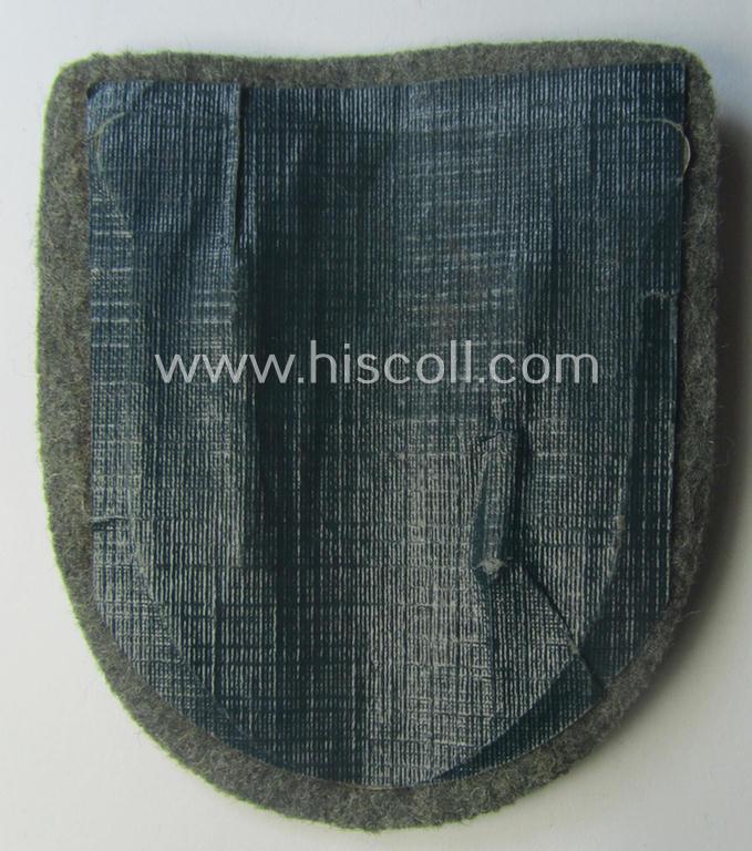 WH (Heeres ie. Waffen-SS) 'Krim'-campaign-shield (by the maker: 'Friedrich Orth') that comes stored in its period (and rarely seen!) 'Zellstoff'-based pouch and that comes in a probably issued- (albeit still 'virtually mint'-), condition